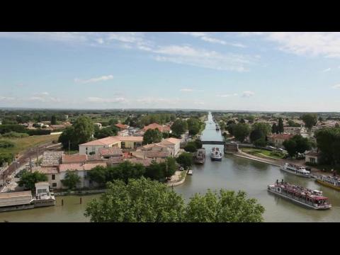 Bridge over the Canal du Rhone-a-Sete, barges sailing - Aigues Mortes, France